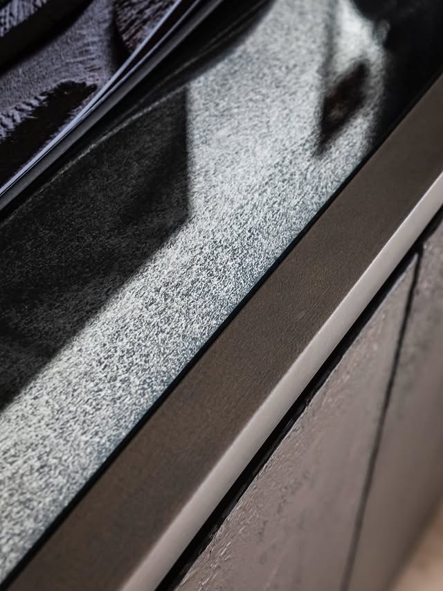 Close-up of an antique-finish RTD mirror panel with speckled patina